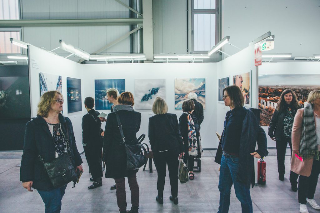 Visitors browsing a trade fair for emerging artists